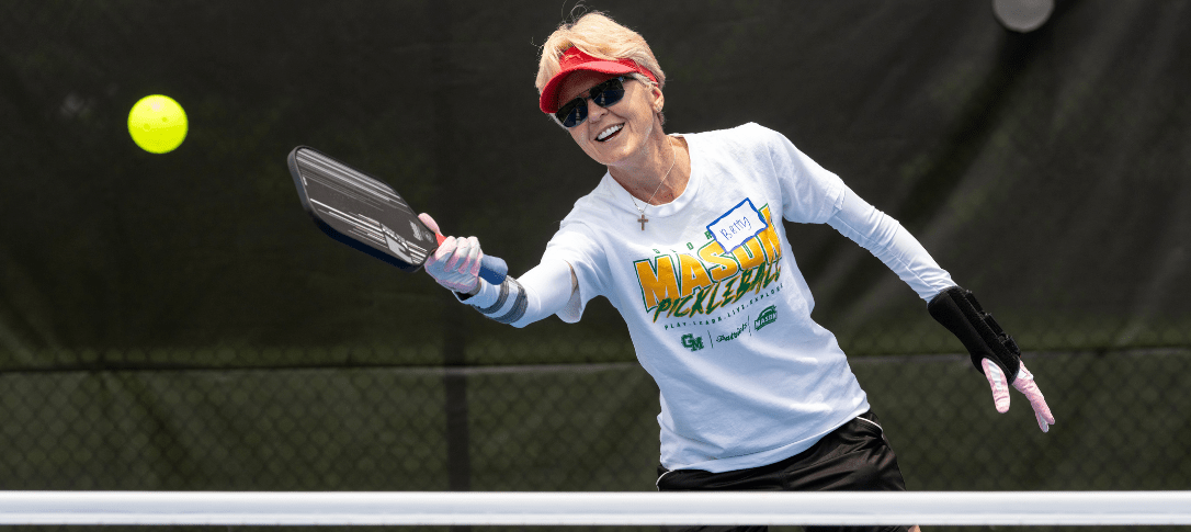 Woman playing pickleball at the Fairfax campus.